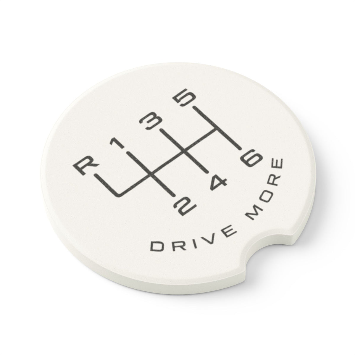 Angled view of absorbent soapstone car coaster with manual transmission shift pattern