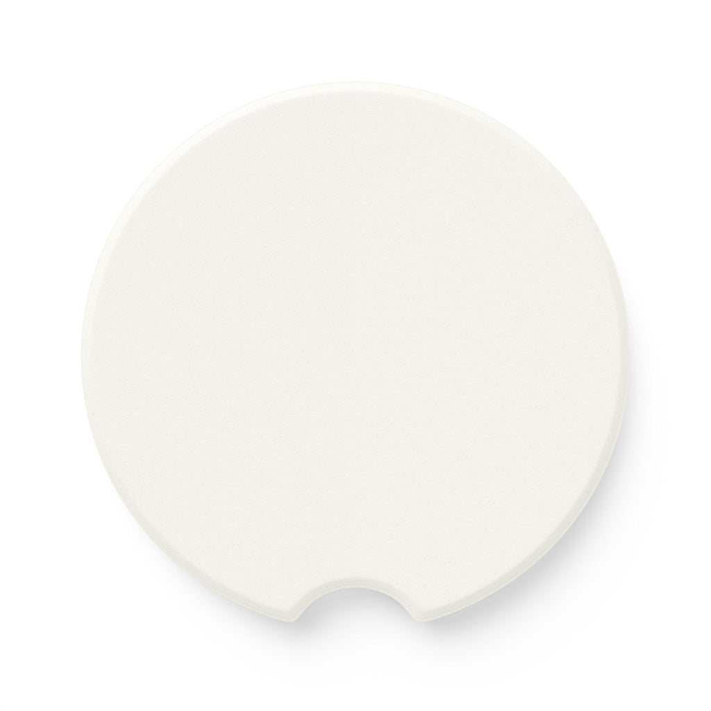 Back side of round soapstone car coaster showing the plain unprinted surface