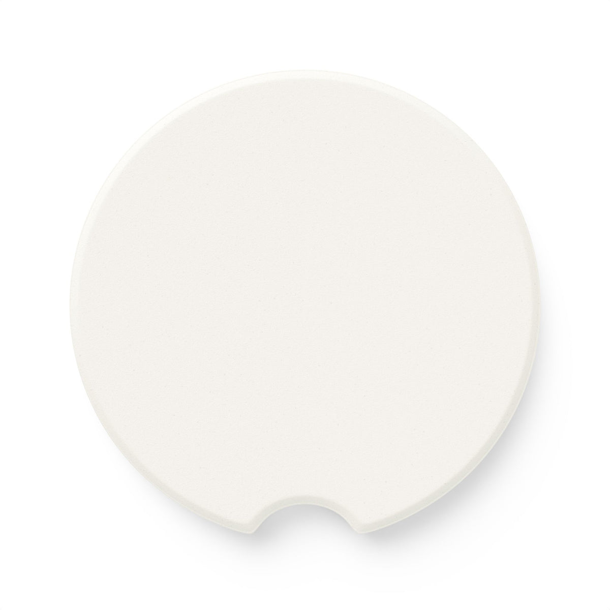 Back side of round soapstone car coaster showing the plain unprinted surface
