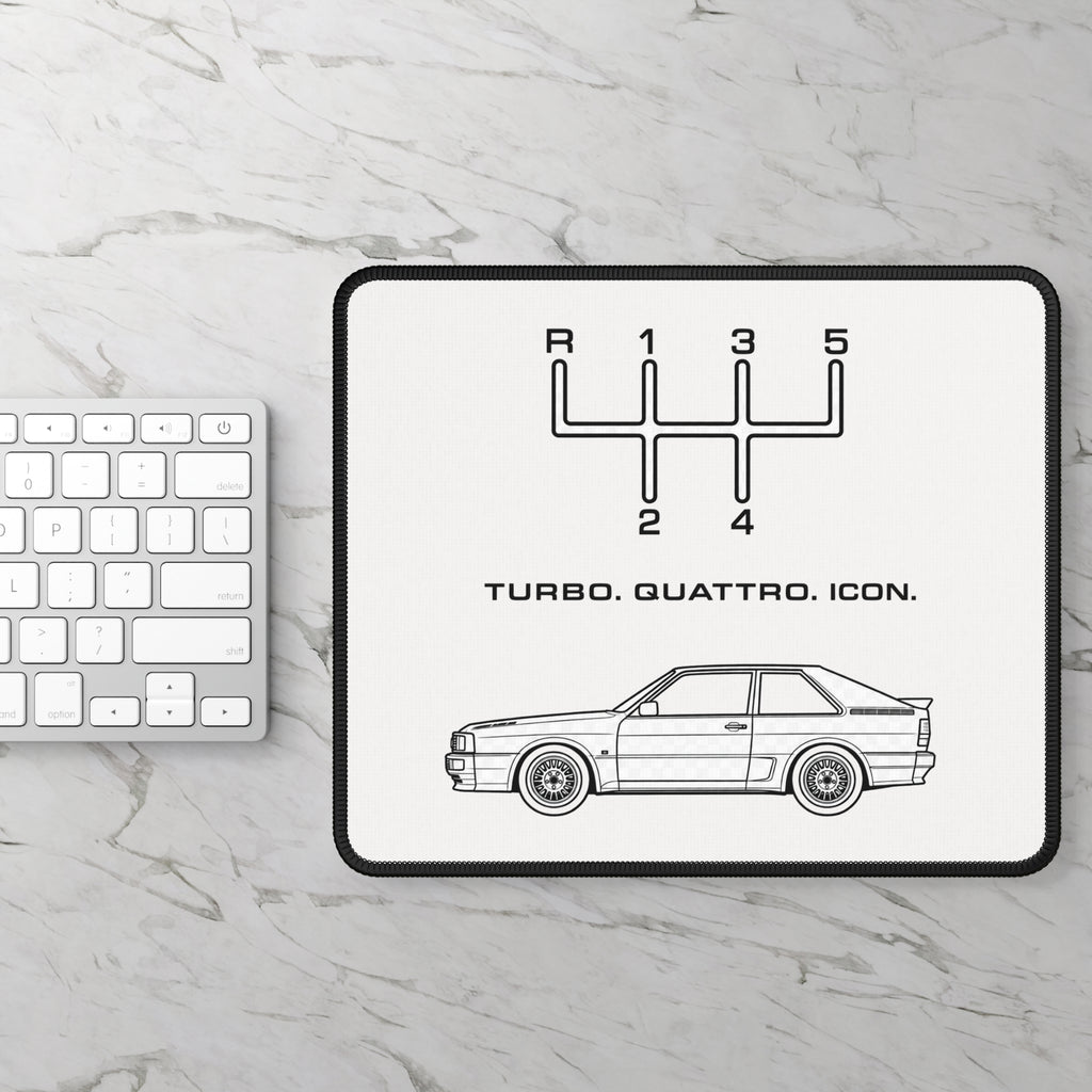 Turbo Quattro Icon mouse pad photographed on a light stone desk alongside a white keyboard