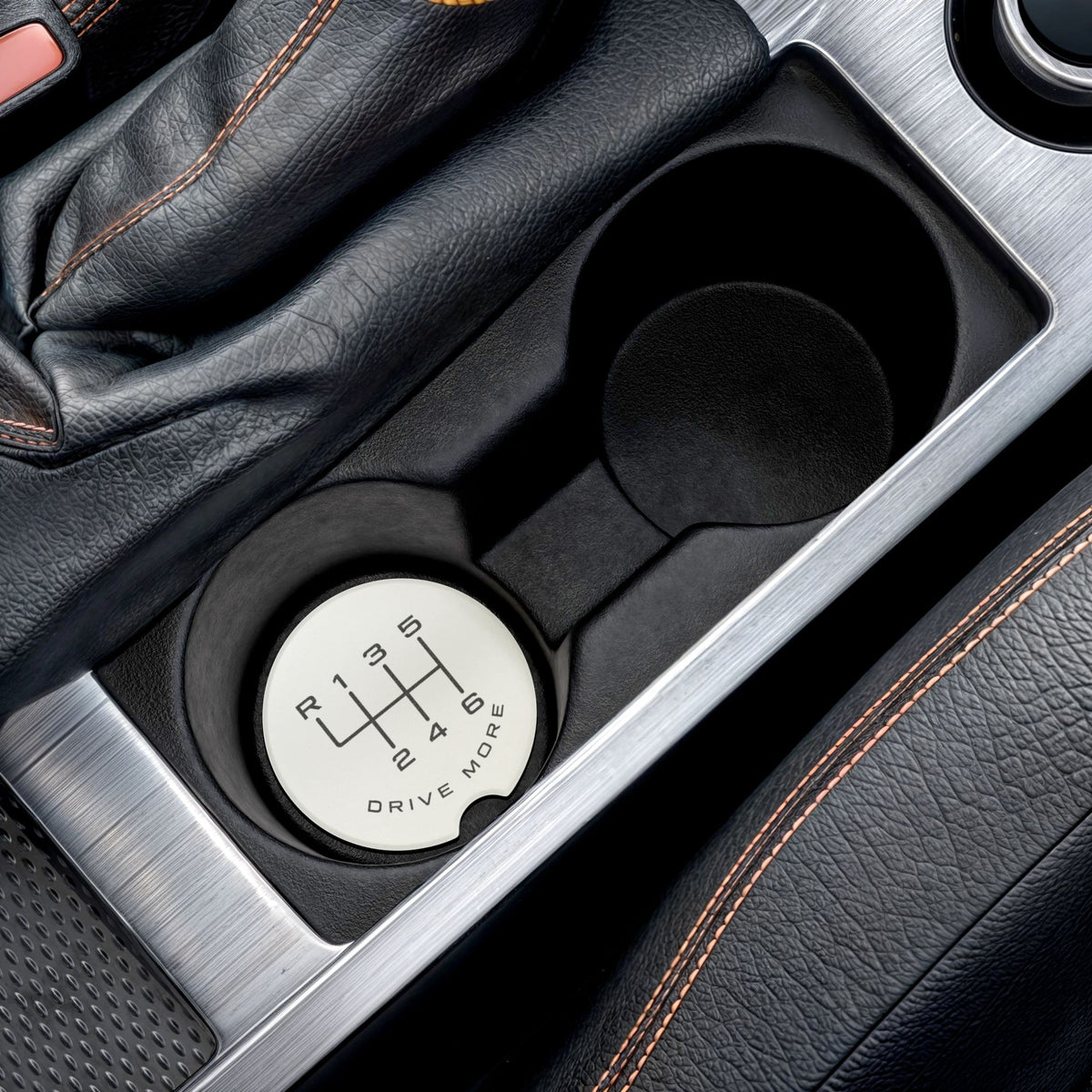 6-speed manual soapstone car coaster placed inside a vehicle cup holder
