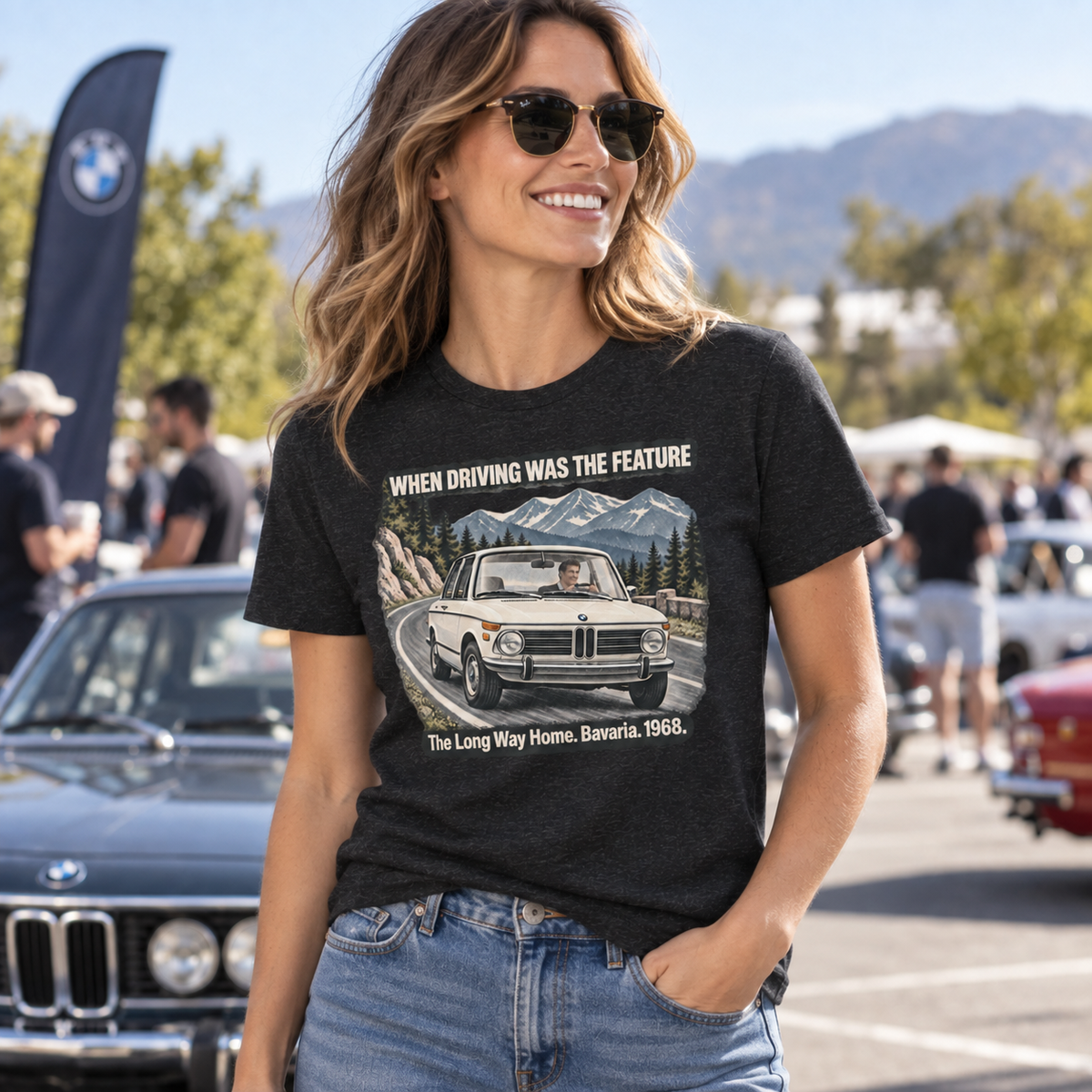 Woman wearing a Black Heather BMW 2002 T-shirt at a classic car meet