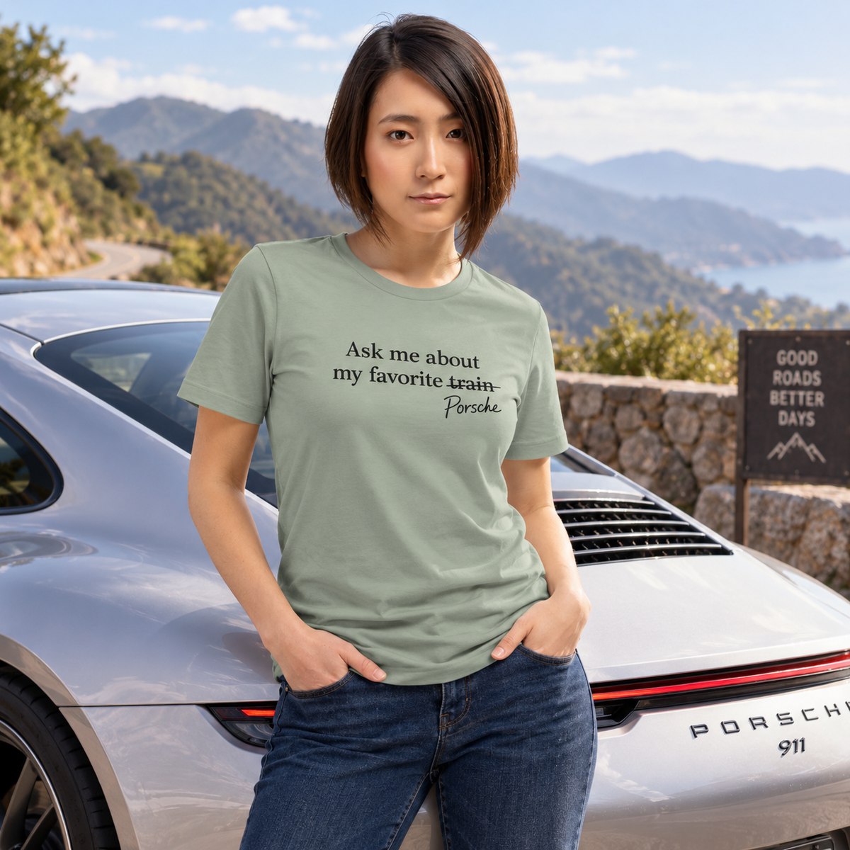 Woman wearing sage Porsches Not Trains T-shirt at an outdoor Porsche car meet