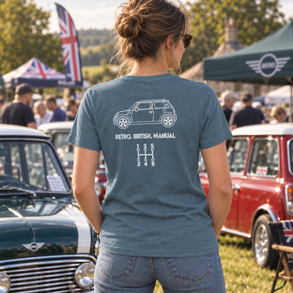 Woman wearing light blue Mini Cooper manual T-shirt with white back graphic at a classic car meet