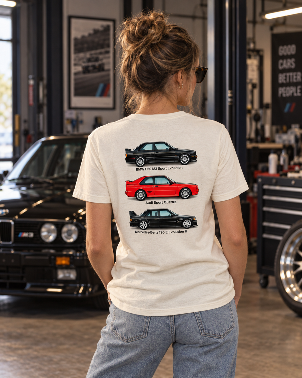 Woman wearing a light-colored German Motorsport Legends back-print T-shirt in a garage