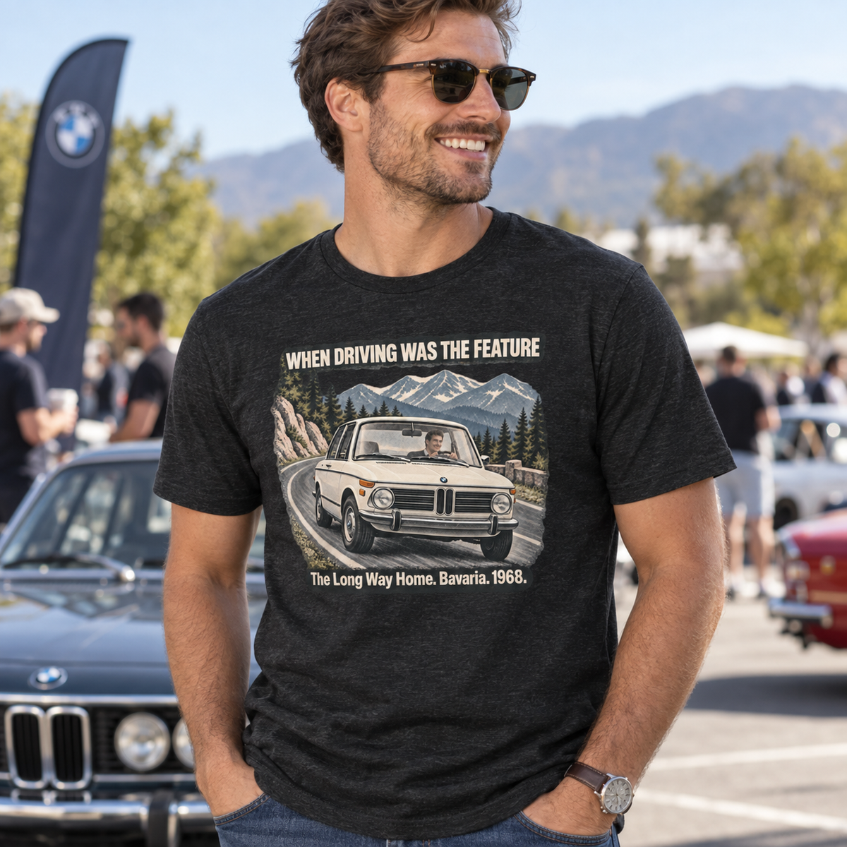 Man wearing a Black Heather BMW 2002 T-shirt at a classic car gathering