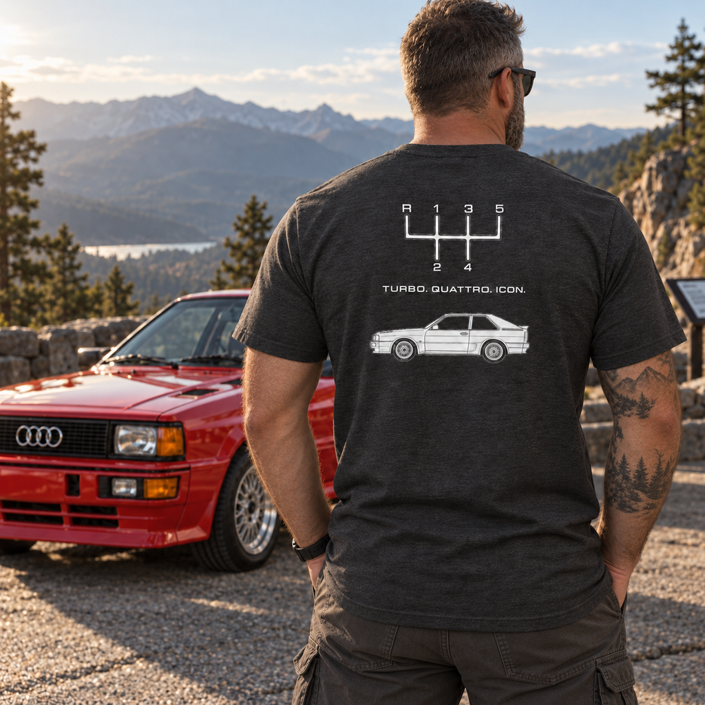 Man wearing Dark Heather Gray Audi Quattro Turbo Icon T-shirt showing the back print at a classic car gathering
