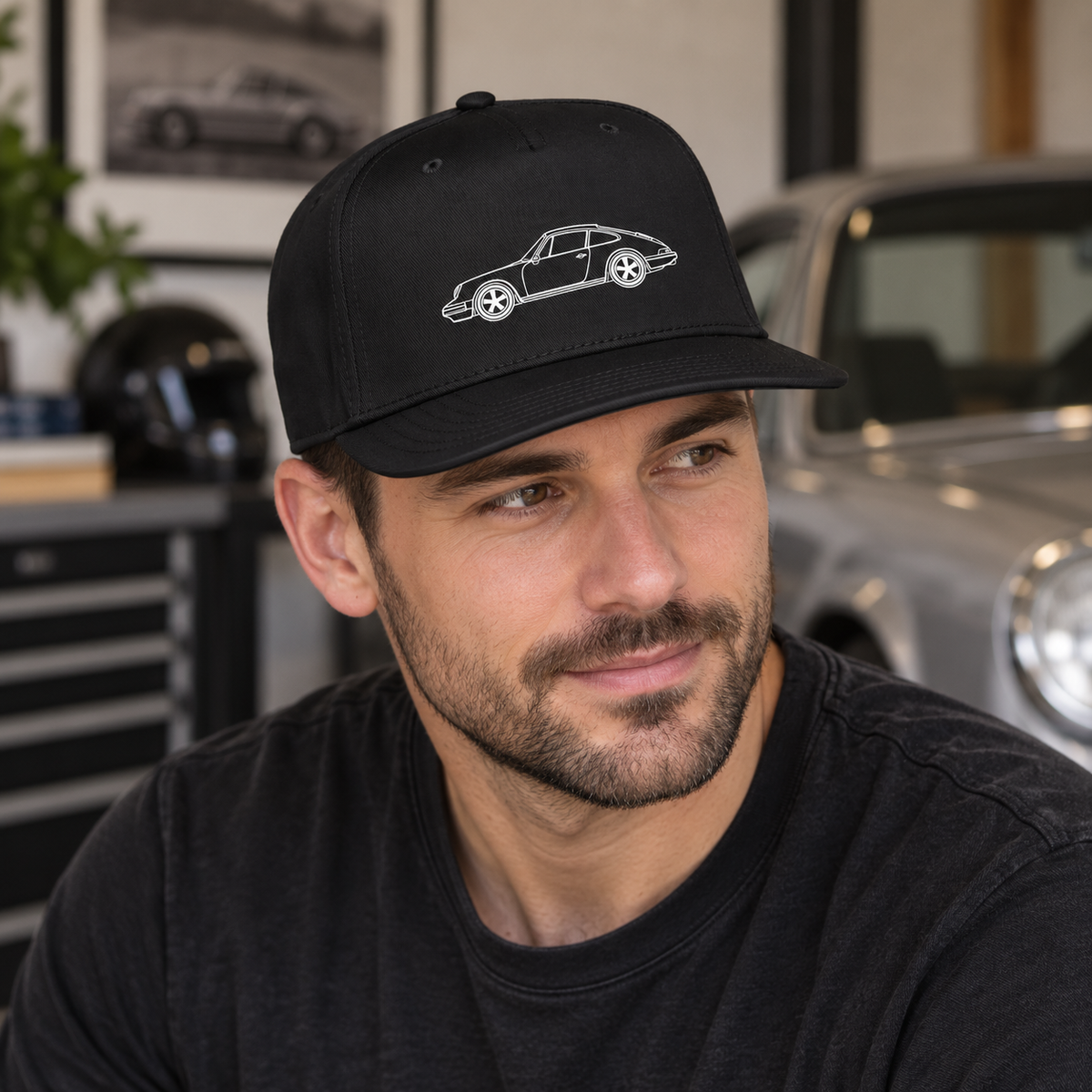 Man wearing black 911 silhouette 5-panel cap