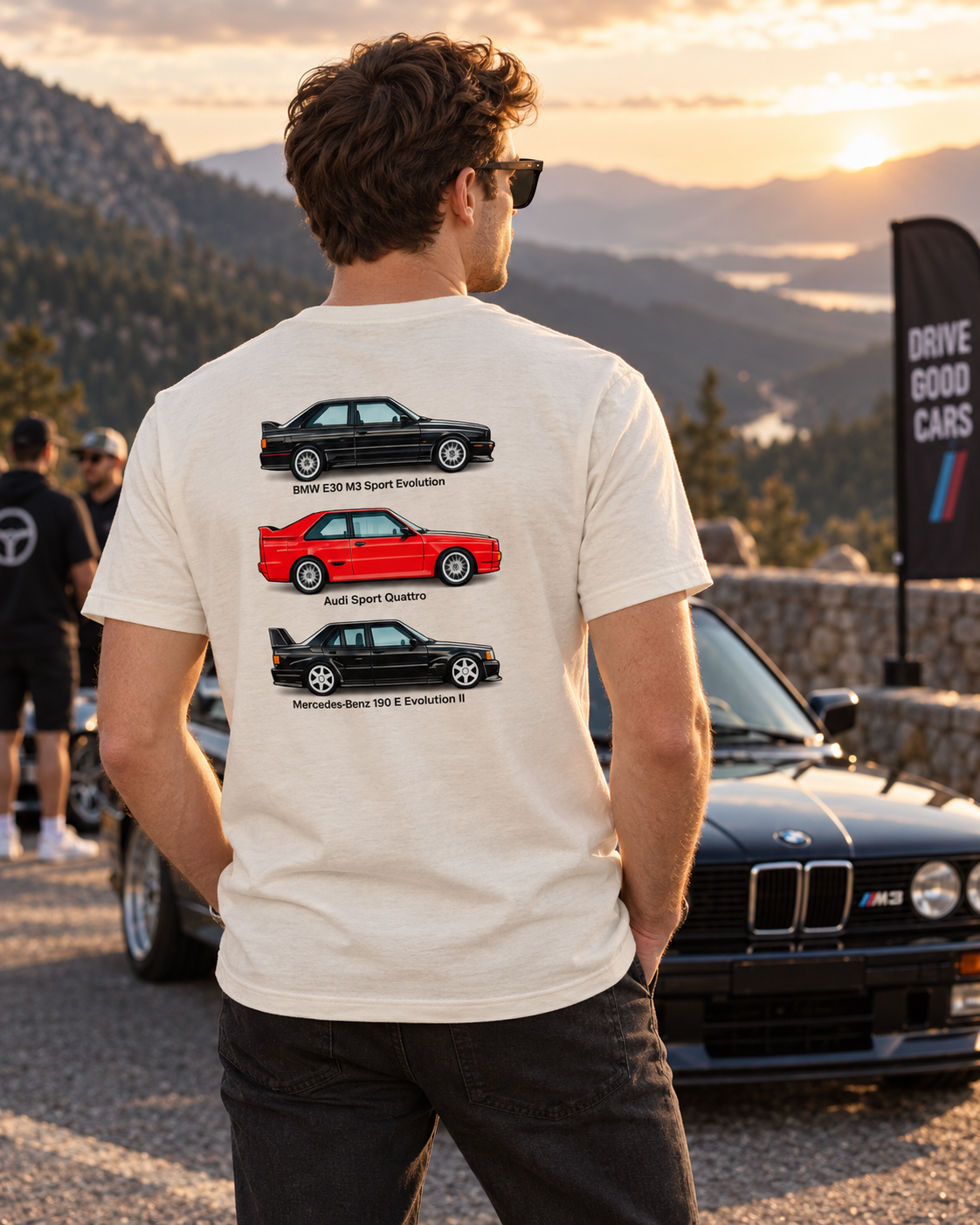 Male model wearing natural white German Motorsport Legends T-shirt on a sunset drive, showing back graphic
