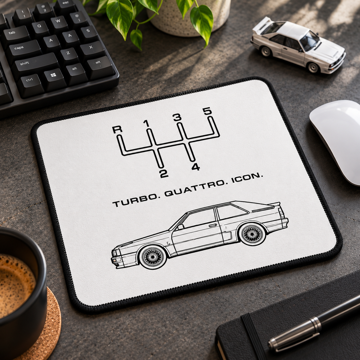 Turbo Quattro Icon mouse pad on a realistic enthusiast desk with black keyboard, computer mouse and small white rally coupe model