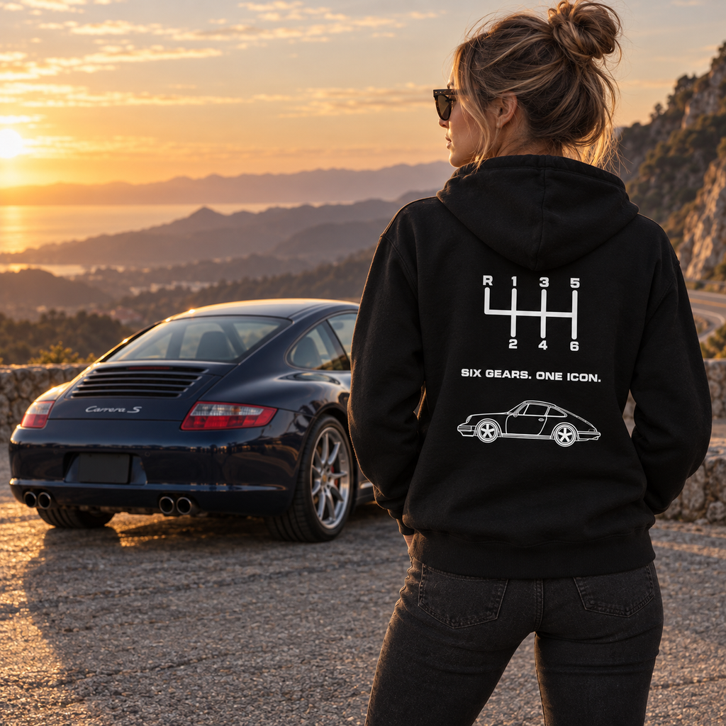 Woman wearing black Six Gears One Icon hoodie at sunset, showing back design