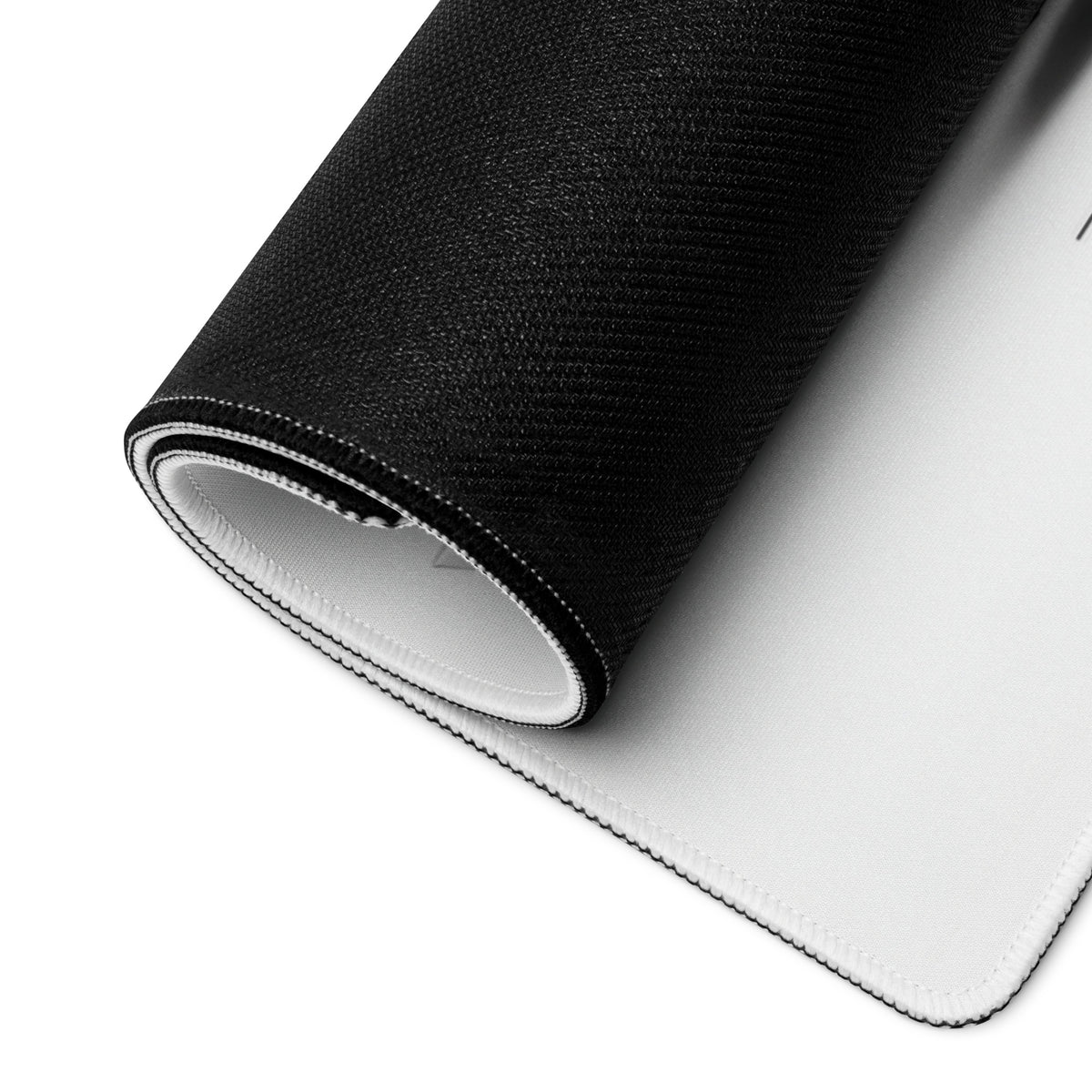 Rolled gaming mouse pad showing flexible construction and black backing