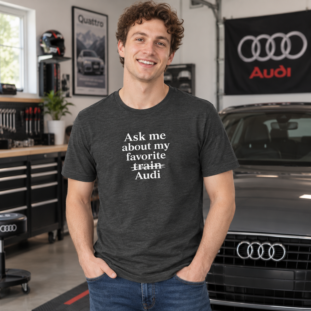Man wearing gray Audi front-print humor T-shirt in a garage