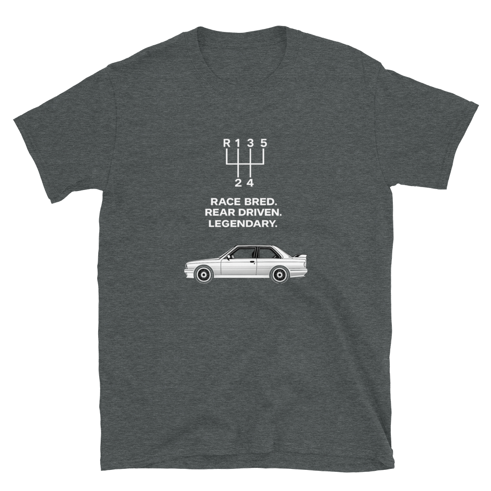 A dark heather gray t-shirt featuring a white graphic of a classic race car and a 5-speed gearshift diagram with the text 'RACE BRED. REAR DRIVEN.
