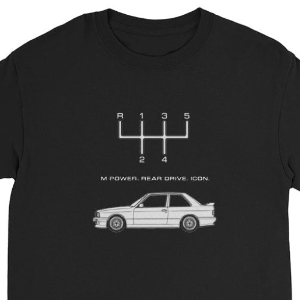 Close-up of E30 M3 long sleeve shirt graphic with 5-speed manual shift pattern, slogan, and classic car illustration.