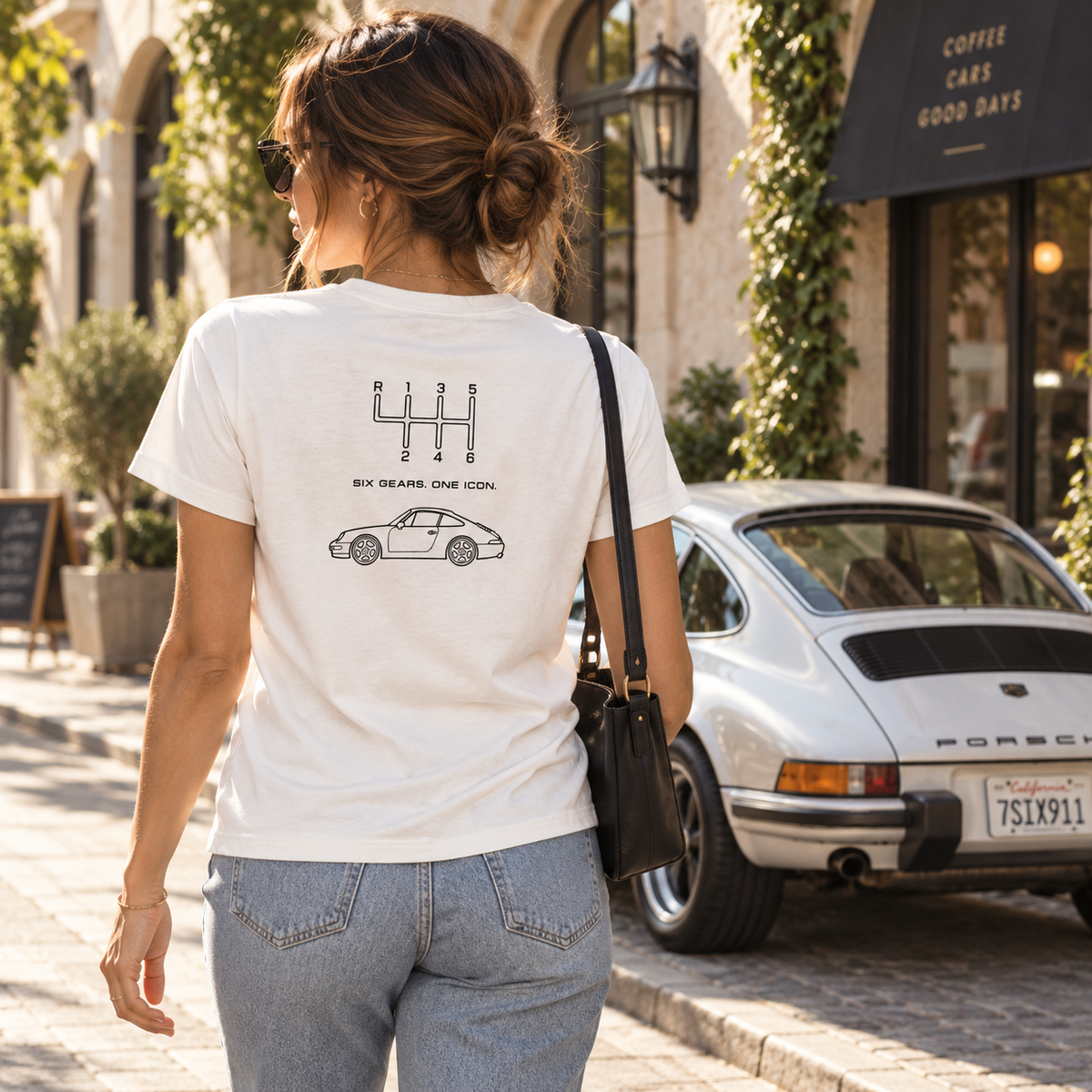 Woman wearing light-colored Classic 911 Six Gears One Icon T-shirt while shopping
