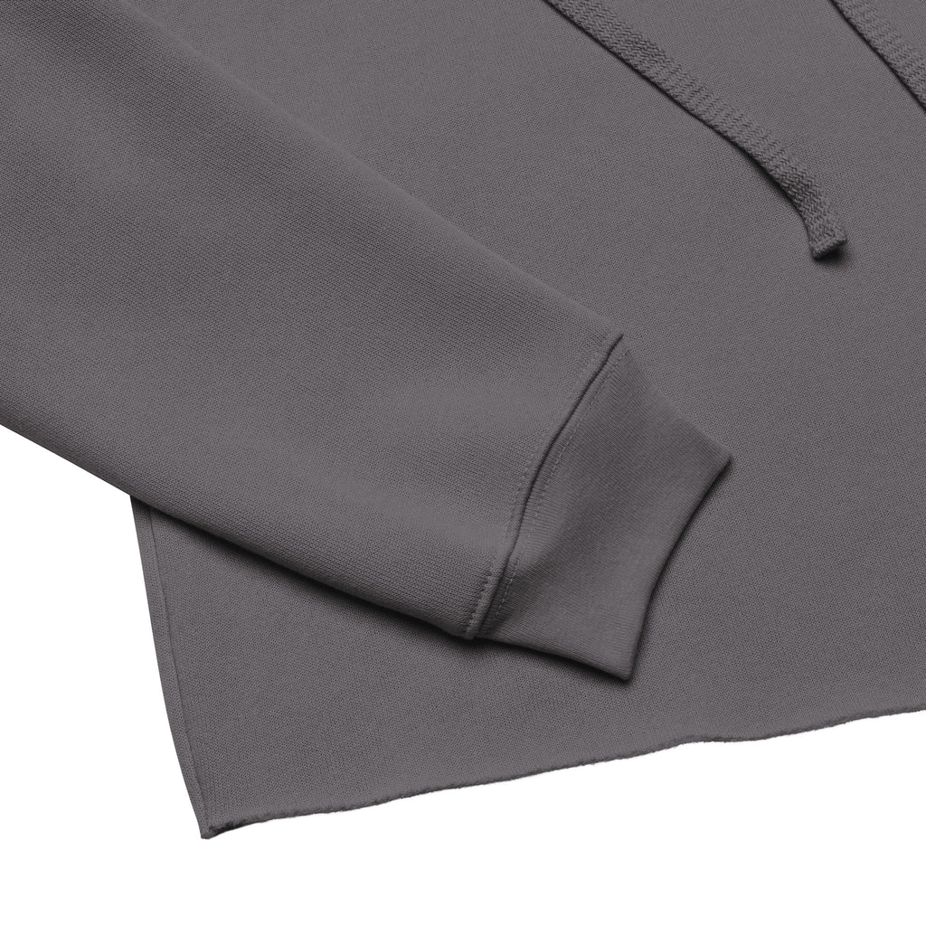 Close-up of Storm gray Zwickau Garage Co. cropped hoodie sleeve, cuff, fleece fabric, and raw hem detail.